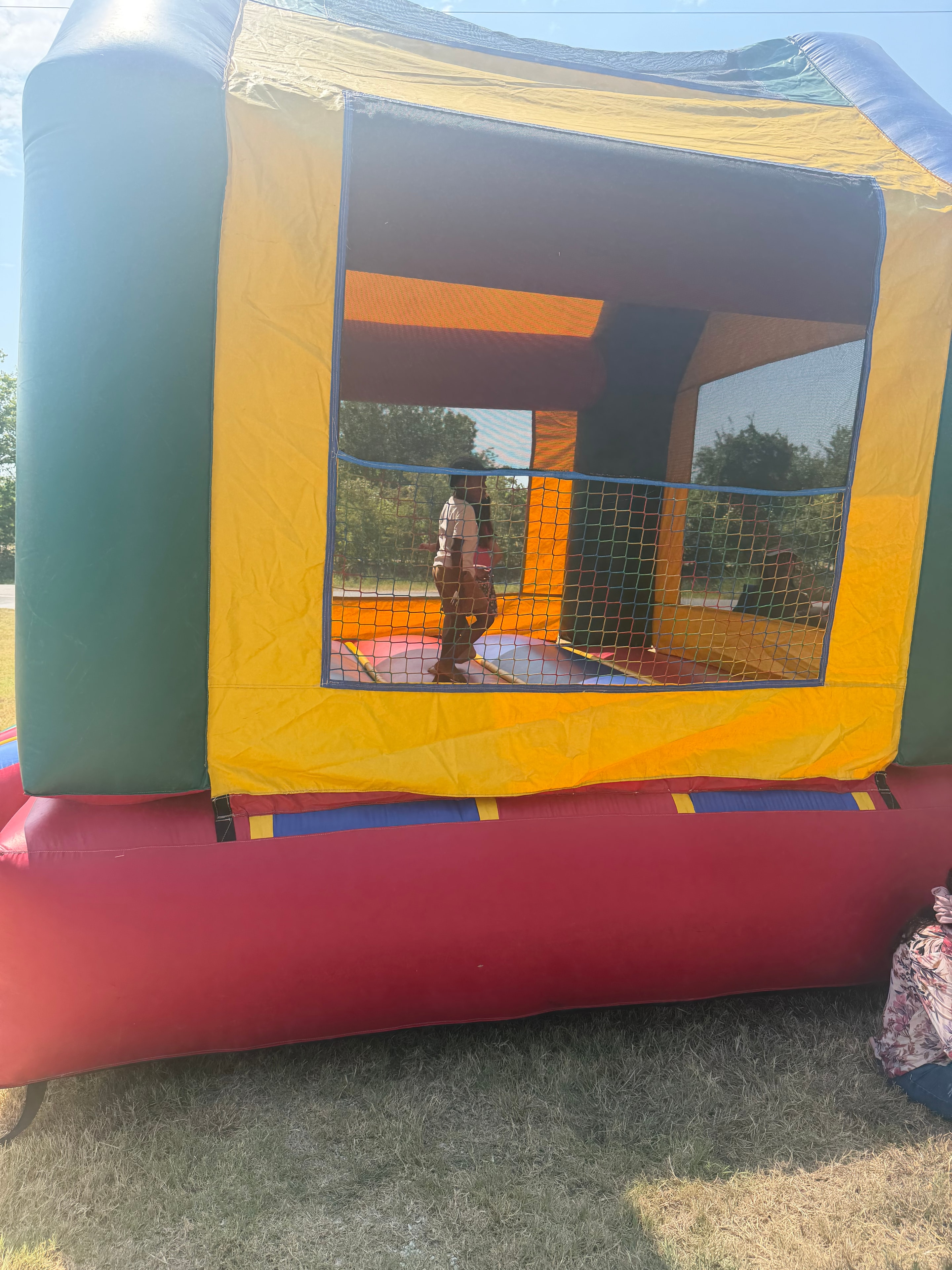 Children playing in bounce house at community fair
